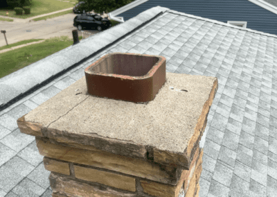 A stone chimney redone by Jensen Enterprises