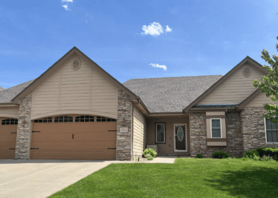 A large home with attached garage with a new roof from Jensen Enterprises